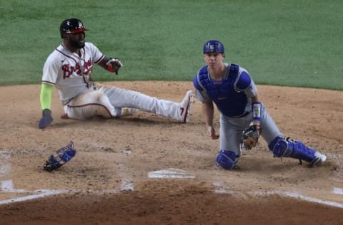 ARLINGTON, TEXAS - OCTOBER 16: Marcell Ozuna #20 of the Atlanta Braves slides into home plate after leaving third base early on a sacrifice fly ball attempt against Will Smith #16 of the Los Angeles Dodgers during the third inning in Game Five of the National League Championship Series at Globe Life Field on October 16, 2020 in Arlington, Texas. (Photo by Rob Carr/Getty Images)