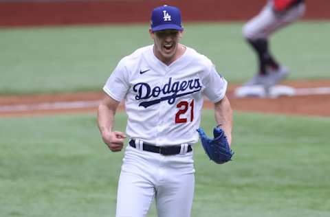 ARLINGTON, TEXAS - OCTOBER 17: Walker Buehler #21 of the Los Angeles Dodgers celebrates after retiring the side with the bases loaded against the Atlanta Braves during the second inning in Game Six of the National League Championship Series at Globe Life Field on October 17, 2020 in Arlington, Texas. (Photo by Tom Pennington/Getty Images)