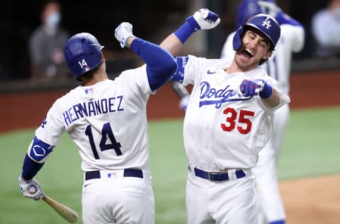 ARLINGTON, TEXAS - OCTOBER 18: Cody Bellinger #35 of the Los Angeles Dodgers is congratulated by Enrique Hernandez #14 after hitting a solo home run against the Atlanta Braves during the seventh inning in Game Seven of the National League Championship Series at Globe Life Field on October 18, 2020 in Arlington, Texas. (Photo by Tom Pennington/Getty Images)