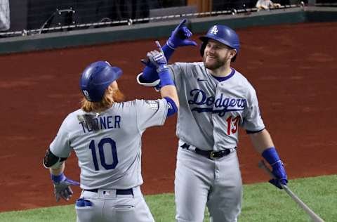 ARLINGTON, TEXAS - OCTOBER 23: Justin Turner #10 of the Los Angeles Dodgers is congratulated by Max Muncy #13 after hitting a solo home run against the Tampa Bay Rays during the first inning in Game Three of the 2020 MLB World Series at Globe Life Field on October 23, 2020 in Arlington, Texas. (Photo by Tom Pennington/Getty Images)