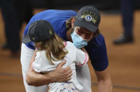 ARLINGTON, TEXAS - OCTOBER 27: Clayton Kershaw #22 of the Los Angeles Dodgers celebrates with his daughter Cali Ann Kershaw after defeating the Tampa Bay Rays 3-1 in Game Six to win the 2020 MLB World Series at Globe Life Field on October 27, 2020 in Arlington, Texas. (Photo by Tom Pennington/Getty Images)