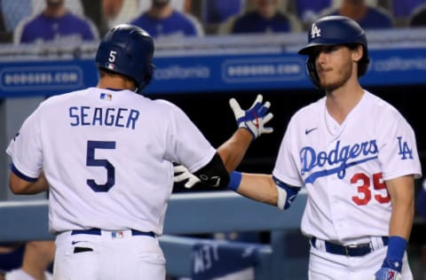 LOS ANGELES, CALIFORNIA - SEPTEMBER 22: Cody Bellinger #35 of the Los Angeles Dodgers celebrates the solo homerun of Corey Seager #5, to take a 6-2 lead over the Oakland Athletics, during the fifth inning at Dodger Stadium on September 22, 2020 in Los Angeles, California. (Photo by Harry How/Getty Images)