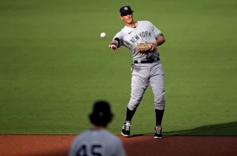 SAN DIEGO, CALIFORNIA - OCTOBER 09: DJ LeMahieu #26 of the New York Yankees throws out the runner against the Tampa Bay Rays during the first inning in Game Five of the American League Division Series at PETCO Park on October 09, 2020 in San Diego, California. (Photo by Christian Petersen/Getty Images)