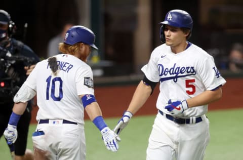 ARLINGTON, TEXAS - OCTOBER 21: Corey Seager #5 of the Los Angeles Dodgers is congratulated by Justin Turner #10 after hitting a solo home run against the Tampa Bay Rays during the eighth inning in Game Two of the 2020 MLB World Series at Globe Life Field on October 21, 2020 in Arlington, Texas. (Photo by Tom Pennington/Getty Images)