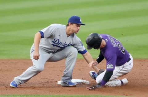 DENVER, COLORADO - SEPTEMBER 18: Corey Seager #5 of the Los Angeles Dodgers catches Trevor Story #27 of Colorado Rockies trying to steal second base in the first inning at Coors Field on September 18, 2020 in Denver, Colorado. (Photo by Matthew Stockman/Getty Images)