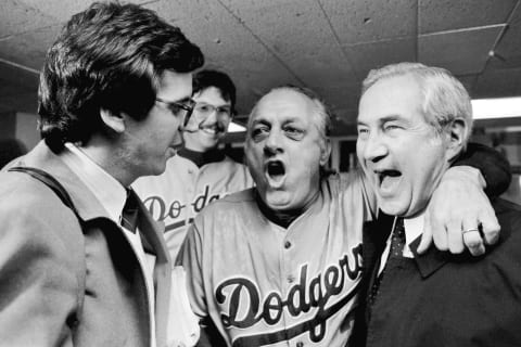 BRONX, NY – OCTOBER 28, 1981: Manager Tommy Lasorda #2 of the Los Angeles Dodgers celebrates with public relations assistant Toby Zwikel and Roland Seidler, team owner, after defeating the New York in the 1981 World Series at Yankee Stadium, Bronx, New York. (Photo by Jayne Kamin-Oncea/Getty Images)