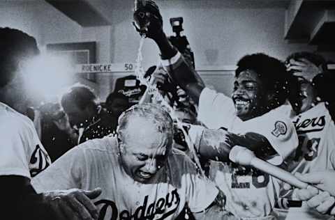 LOS ANGELES, CA - OCTOBER 1981: Pedro Guerrero #28 pours champagne on Manager Tommy Lasorda #2 of the Los Angeles Dodgers after defeating the Houston Astros in the divisional playoffs at Dodger Stadium, Los Angeles, California. (Photo by Jayne Kamin-Oncea/Getty Images)