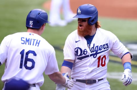 ARLINGTON, TEXAS - OCTOBER 17: Justin Turner #10 of the Los Angeles Dodgers is congratulated by Will Smith #16 after hitting a solo home run against the Atlanta Braves during the first inning in Game Six of the National League Championship Series at Globe Life Field on October 17, 2020 in Arlington, Texas. (Photo by Tom Pennington/Getty Images)