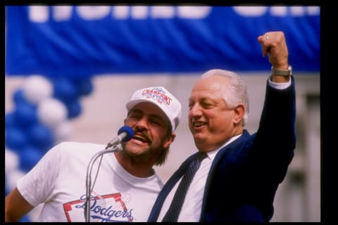 LOS ANGELES, CA – OCTOBER 25: Outfielder Kirk Gibson #23 and manager Tommy Lasorda #2 of the Los Angeles Dodgers speak to the croad at the Victory Parade for the Los Angeles Dodgers on October 25, 1988 in Los Angeles, California. (Photo by Mike Powell/Getty Images)