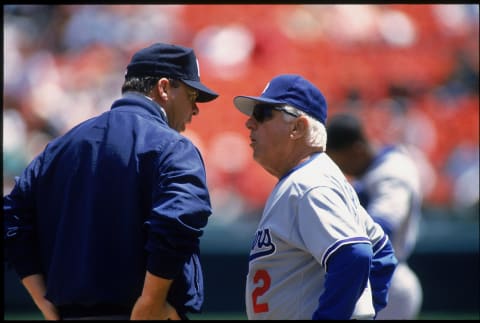 1996: Manager Tom Lasorda #2 of the Los Angeles Dodgers aruges with an umpire circa 1996. (Photo by Brad Mangin/MLB Photos)