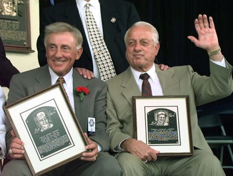 Phil Niekro (L) and Tom Lasorda hold their awards after being inducted into the Nation Baseball Hall of Fame 03 August in Cooperstown, NY. Niekro was inducted for his knuckleball and Lasorda for his longtime career with the L.A. Dodgers as the team’s manager. (Electronic Image) AFP PHOTO Don EMMERT (Photo by Don EMMERT / AFP) (Photo credit should read DON EMMERT/AFP via Getty Images)