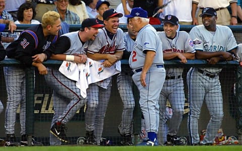 Former Los Angeles Dodgers manager Tommy Lasorda (C front) shares a laugh with the National League bench after Lasorda was hit with a bat while coaching third base during the baseball All-Star game 10 July, 2001 at Safeco Field in Seattle, Washington. AFP PHOTO/John MABANGLO (Photo by JOHN G. MABANGLO / AFP) (Photo by JOHN G. MABANGLO/AFP via Getty Images)