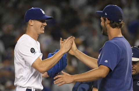 LOS ANGELES, CA - AUGUST 03: Walker Buehler #21 of the Los Angeles Dodgers is congratulated by Clayton Kershaw #22 after he pitched a complete game to win over the San Diego Padresat Dodger Stadium on August 3, 2019 in Los Angeles, California. Dodgers won 4-1. (Photo by John McCoy/Getty Images)