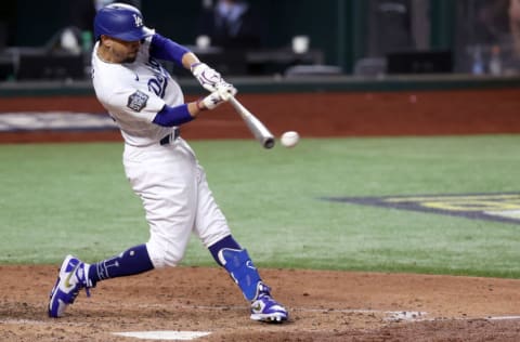 ARLINGTON, TEXAS - OCTOBER 27: Mookie Betts #50 of the Los Angeles Dodgers hits a double against the Tampa Bay Rays during the sixth inning in Game Six of the 2020 MLB World Series at Globe Life Field on October 27, 2020 in Arlington, Texas. (Photo by Tom Pennington/Getty Images)