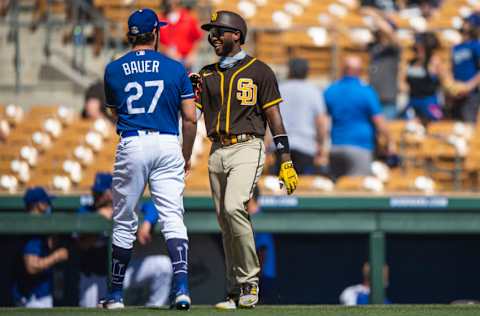 GLENDALE, AZ - MARCH 06: Trevor Bauer #27 of the Los Angeles Dodgers jokes with Jurickson Profar #10 of the San Diego Padres during the game at Camelback Ranch on March 6, 2021 in Glendale, Arizona. (Photo by Matt Thomas/San Diego Padres/Getty Images)