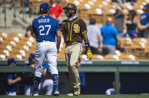 GLENDALE, AZ - MARCH 06: Trevor Bauer #27 of the Los Angeles Dodgers jokes with Jurickson Profar #10 of the San Diego Padres during the game at Camelback Ranch on March 6, 2021 in Glendale, Arizona. (Photo by Matt Thomas/San Diego Padres/Getty Images)