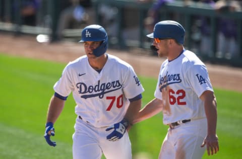 GLENDALE, AZ - MARCH 01: DJ Peters #70 of the Los Angeles Dodgers gets greeted by Luke Raley #62 after hitting a home run during a spring training game against the Colorado Rockies at Camelback Ranch on March 1, 2021 in Glendale, Arizona. (Photo by Rob Tringali/Getty Images)