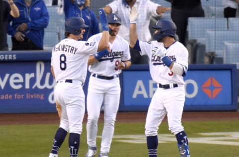 LOS ANGELES, CALIFORNIA - APRIL 10: Chris Taylor #3 of the Los Angeles Dodgers celebrates his three run homerun with Zach McKinstry #8 and Gavin Lux #9, to take a 5-1 lead over the Washington Nationals, during the second inning at Dodger Stadium on April 10, 2021 in Los Angeles, California. (Photo by Harry How/Getty Images)