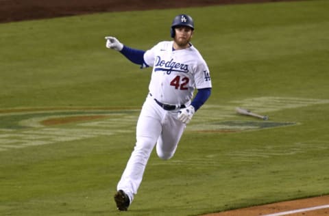 LOS ANGELES, CALIFORNIA - APRIL 15: Max Muncy #13 of the Los Angeles Dodgers celebrates his three run homerun, to take a 6-5 lead over the Colorado Rockies, during the seventh inning at Dodger Stadium on April 15, 2021 in Los Angeles, California. All players are wearing the number 42 in honor of Jackie Robinson Day. (Photo by Harry How/Getty Images)