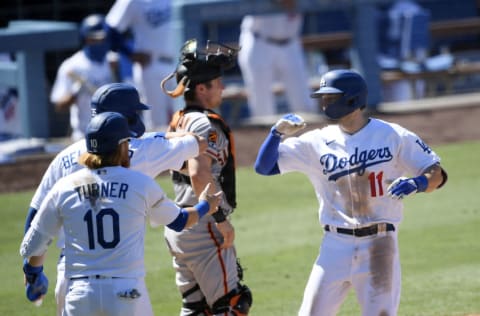 LOS ANGELES, CA - AUGUST 09: A.J. Pollock #11 of the Los Angeles Dodgers celebrates his three run home run with Justin Turner #10 and Cody Bellinger #35 against relief pitcher Tyler Rogers #71 of the San Francisco Giants during the seventh inning at Dodger Stadium on August 9, 2020 in Los Angeles, California. (Photo by Kevork Djansezian/Getty Images)