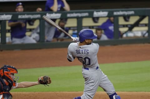 HOUSTON, TEXAS - JULY 29: Mookie Betts #50 of the Los Angeles Dodgers doubles in a run in the eleventh inning against the Houston Astros at Minute Maid Park on July 29, 2020 in Houston, Texas. (Photo by Bob Levey/Getty Images)