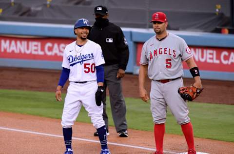 LOS ANGELES, CALIFORNIA - SEPTEMBER 26: Mookie Betts #50 of the Los Angeles Dodgers and Albert Pujols #5 of the Los Angeles Angels talk at first base during the first inning at Dodger Stadium on September 26, 2020 in Los Angeles, California. (Photo by Harry How/Getty Images)