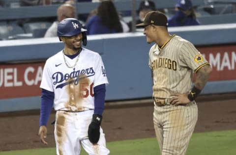 LOS ANGELES, CALIFORNIA - APRIL 23: Mookie Betts #50 of the Los Angeles Dodgers and Manny Machado #13 of the San Diego Padres chat on third base during a game at Dodger Stadium on April 23, 2021 in Los Angeles, California. The San Diego Padres won, 6-1. (Photo by Michael Owens/Getty Images)