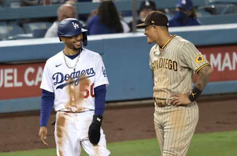 LOS ANGELES, CALIFORNIA - APRIL 23: Mookie Betts #50 of the Los Angeles Dodgers and Manny Machado #13 of the San Diego Padres chat on third base during a game at Dodger Stadium on April 23, 2021 in Los Angeles, California. The San Diego Padres won, 6-1. (Photo by Michael Owens/Getty Images)