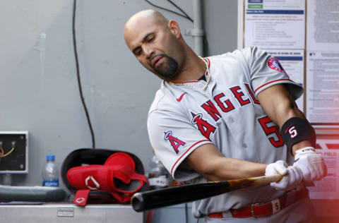 SEATTLE, WASHINGTON - MAY 02: Albert Pujols #5 of the Los Angeles Angels swings his bat in the dugout during the game against the Seattle Mariners at T-Mobile Park on May 02, 2021 in Seattle, Washington. (Photo by Steph Chambers/Getty Images)