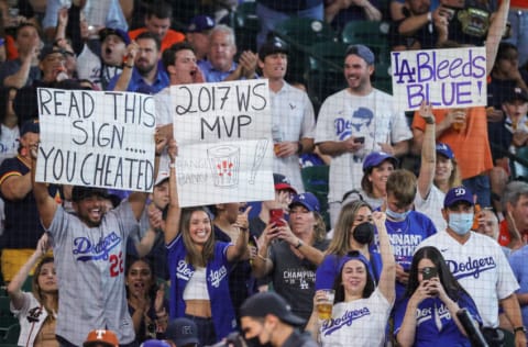 HOUSTON, TEXAS - MAY 25: Fans hold sings during the first inning of a game between the Houston Astros and the Los Angeles Dodgers at Minute Maid Park on May 25, 2021 in Houston, Texas. (Photo by Carmen Mandato/Getty Images)