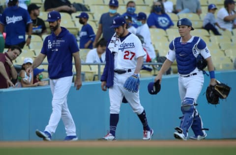 LOS ANGELES, CALIFORNIA - JUNE 12: Pitching coach Mark Prior #99, Trevor Bauer #27 and Will Smith #16 of the Los Angeles Dodgers walk out of the bullpen before the game against the Texas Rangers at Dodger Stadium on June 12, 2021 in Los Angeles, California. (Photo by Katelyn Mulcahy/Getty Images)