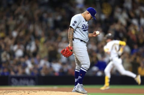 SAN DIEGO, CALIFORNIA - JUNE 21: Julio Urias #7 of the Los Angeles Dodgers looks on as Jake Cronenworth #9 of the San Diego Padres rounds the bases after hitting a two-run homerun during the fifth inning of a game at PETCO Park on June 21, 2021 in San Diego, California. (Photo by Sean M. Haffey/Getty Images)