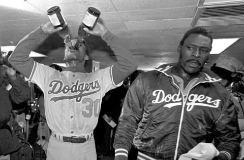 NEW YORK, NY - OCTOBER 28: Darrell Thomas #30 of the Los Angeles Dodgers drinks champagne as starting pitcher Dave Stewart #48 looks on in the clubhouse after winning the 1981 World Series against the NY Yankees at Yankee Stadium on October 28, 1981 in New York, New York. (Photo by Jayne Kamin-Oncea/Getty Images)