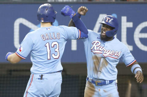 ARLINGTON, TX - JUNE 27: Joey Gallo #13 of the Texas Rangers and teammate Adolis Garcia #53 celebrate Gallo's two-run home run against the Kansas City Royals during the first inning at Globe Life Field on June 27, 2021 in Arlington, Texas. (Photo by Ron Jenkins/Getty Images)