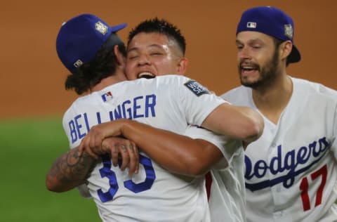 ARLINGTON, TEXAS - OCTOBER 27: Cody Bellinger #35 of the Los Angeles Dodgers celebrates with Julio Urias #7 and Joe Kelly #17 after defeating the Tampa Bay Rays 3-1 in Game Six to win the 2020 MLB World Series at Globe Life Field on October 27, 2020 in Arlington, Texas. (Photo by Ronald Martinez/Getty Images)