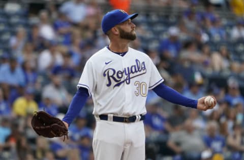 KANSAS CITY, MISSOURI - JULY 16: Starting pitcher Danny Duffy #30 of the Kansas City Royals reacts after the stadium lights came on during his windup against the Baltimore Orioles in the first inning at Kauffman Stadium on July 16, 2021 in Kansas City, Missouri. (Photo by Ed Zurga/Getty Images)