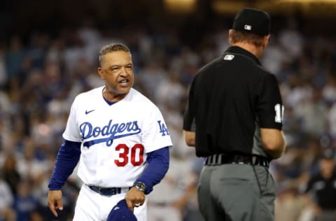 LOS ANGELES, CALIFORNIA - JULY 22: Manager Dave Roberts #30 of the Los Angeles Dodgers reacts after first base umpire Ed Hickox #15 made the call on a no-swing for a walk to Darin Ruf of the San Francisco Giants to tie the game 3-3 in the ninth inning at Dodger Stadium on July 22, 2021 in Los Angeles, California. (Photo by Katelyn Mulcahy/Getty Images)