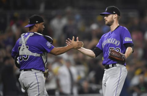 SAN DIEGO, CA - JULY 31: Daniel Bard #52 of the Colorado Rockies is congratulated by Elias Diaz #35 after the Rockies beat the San Diego Padres 5-3 in a baseball game at Petco Park on July 31, 2021 in San Diego, California. (Photo by Denis Poroy/Getty Images)