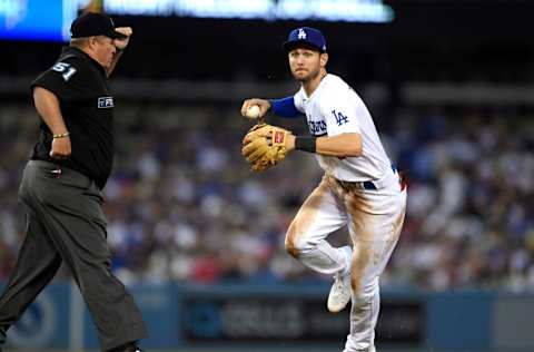 LOS ANGELES, CA - AUGUST 07: Second baseman Trea Turner #6 of the Los Angeles Dodgers throws the ball to first base for the last out of the fifth inning with umpire Marvin Hudson #51 looking on at Dodger Stadium on August 7, 2021 in Los Angeles, California. (Photo by Kevork Djansezian/Getty Images)