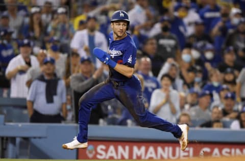 LOS ANGELES, CA - AUGUST 20: Trea Turner #6 of the Los Angeles Dodgers flies around third base on his way to score a run on a double by Max Muncy #13 during the third inning against the New York Mets at Dodger Stadium on August 20, 2021 in Los Angeles, California. (Photo by Kevork Djansezian/Getty Images)