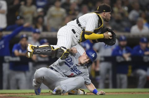 SAN DIEGO, CA - AUGUST 25: Will Smith #16 of the Los Angeles Dodgers is tagged out by Victor Caratini #17 of the San Diego Padres during the 13th inning of a baseball game at Petco Park on August 25, 2021 in San Diego, California. (Photo by Denis Poroy/Getty Images)