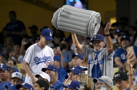 LOS ANGELES, CA - AUGUST 03: A Los Angeles Dodgers fan pounds on inflatable trash can during the game against the Houston Astros at Dodger Stadium on August 3, 2021 in Los Angeles, California. (Photo by Jayne Kamin-Oncea/Getty Images)