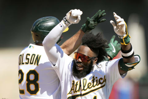 OAKLAND, CALIFORNIA – AUGUST 04: Matt Olson #28 and Josh Harrison #1 of the Oakland Athletics celebrates after Olson hit a walk-off two-run RBI double in the bottom of the tenth inning to defeat the San Diego Padres 5-4 at RingCentral Coliseum on August 04, 2021 in Oakland, California. (Photo by Thearon W. Henderson/Getty Images)