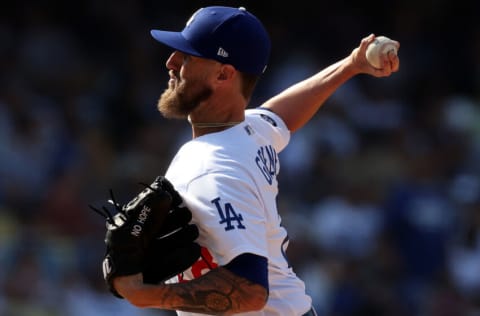 LOS ANGELES, CALIFORNIA - AUGUST 22: Shane Greene #28 of the Los Angeles Dodgers throws against the New York Mets at Dodger Stadium on August 22, 2021 in Los Angeles, California. (Photo by Ronald Martinez/Getty Images)