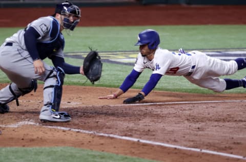 ARLINGTON, TEXAS - OCTOBER 27: Mookie Betts #50 of the Los Angeles Dodgers slides in safely past Mike Zunino #10 of the Tampa Bay Rays to score a run on a fielders choice hit by Corey Seager during the sixth inning in Game Six of the 2020 MLB World Series at Globe Life Field on October 27, 2020 in Arlington, Texas. (Photo by Tom Pennington/Getty Images)