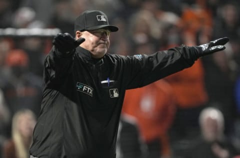 SAN FRANCISCO, CALIFORNIA - SEPTEMBER 03: Umpire Tony Randazzo #11 gives a safe call after reviewing a play for Buster Posey #28 of the San Francisco Giants at first base on a throwing error from Trea Turner #6 of the Los Angeles Dodgers in the bottom of the 11th inning at Oracle Park on September 03, 2021 in San Francisco, California. The play ended the game as Brandon Belt scored from third giving the Giants a 3-2 victory. (Photo by Thearon W. Henderson/Getty Images)