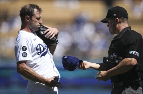 LOS ANGELES, CALIFORNIA - SEPTEMBER 12: Max Scherzer #31 of the Los Angeles Dodgers has his hat and belt checked for foreign substances by umpires after the first inning against the San Diego Padres at Dodger Stadium on September 12, 2021 in Los Angeles, California. (Photo by Meg Oliphant/Getty Images)