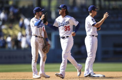 LOS ANGELES, CALIFORNIA - SEPTEMBER 12: Cody Bellinger #35 of the Los Angeles Dodgers celebrates the win over the San Diego Padres with Trea Turner #6 at Dodger Stadium on September 12, 2021 in Los Angeles, California. (Photo by Meg Oliphant/Getty Images)