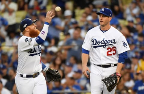 LOS ANGELES, CALIFORNIA - OCTOBER 03: Justin Turner #10 and David Freese #25 of the Los Angeles Dodgers celebrate a double play against Juan Soto #22 of the Washington Nationals during the second inning of game one of the National League Division Series at Dodger Stadium on October 03, 2019 in Los Angeles, California. (Photo by Harry How/Getty Images)