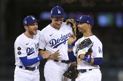 LOS ANGELES, CA - SEPTEMBER 11: Mookie Betts #50 of the Los Angeles Dodgers celebrate with Trea Turner #6 and Corey Seager #5 after defeating the San Diego Padres 5-4 at Dodger Stadium on September 11, 2021 in Los Angeles, California. (Photo by Kevork Djansezian/Getty Images)